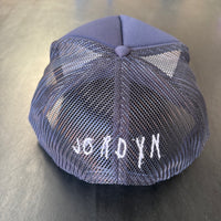 A picture showing that Jordyn's signature is embroidered on the back of our Nope Not Today Maybe Tomorrow Trucker Hat.
