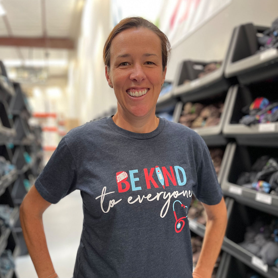 Julie in our Nurse style Be Kind to Everyone® shirt (she is wearing a small).