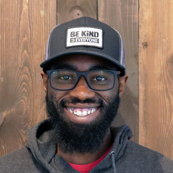 Be Kind to Everyone® accessories collection image featuring Key wearing our Hudson Trucker Hat.