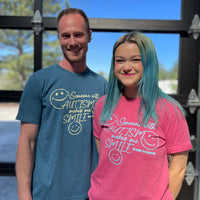 Our Autism Awareness T-Shirt Surprise Packs contain a short-sleeved tee in heather raspberry or heather deep teal with our Someone with Autism Makes Me Smile / Be Kind to Everyone® design. In this photo, Ryan is wearing a large, and Sarah is wearing a medium.