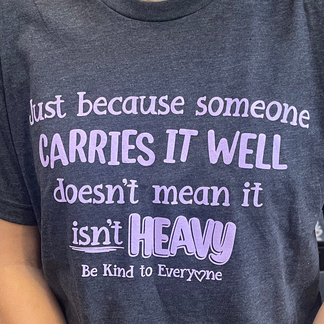 Close up image of our Carries it Well Be Kind to Everyone® t-shirt.