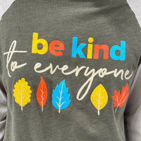 Close-up image of our Fall Be Kind to Everyone® Raglan tee.