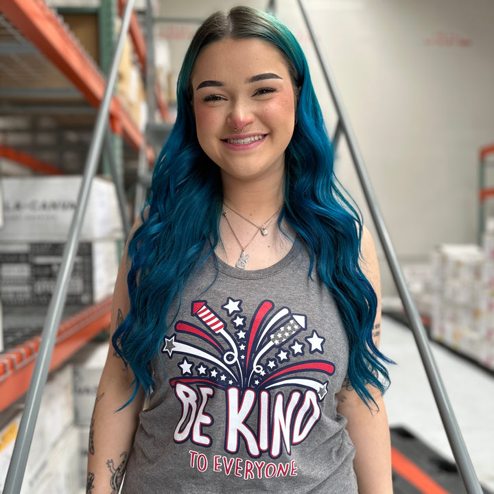 Sarah, modeling a medium in our adult women's 4th of July Be Kind to Everyone® racerback tank top.