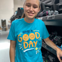 Jordyn, at the shirt shop, modeling a small in our Have A Good Day short-sleeved t-shirt.