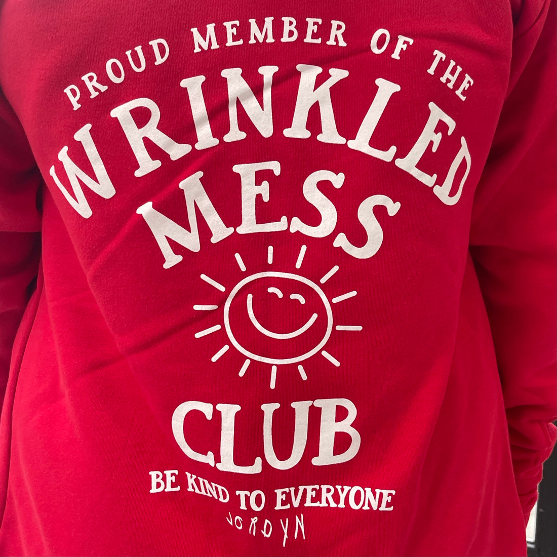 Zoomed in image of the back of our Wrinkled Mess Club Hoodie.