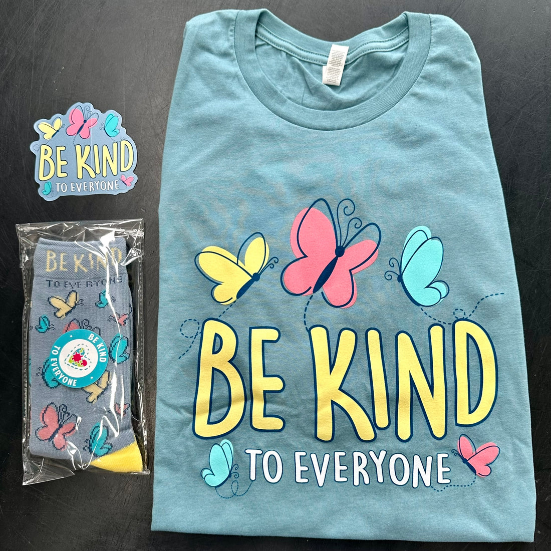 Our Butterfly Be Kind to Everyone® Tee and Sock Pack includes a short-sleeve tee with matching socks and decal.