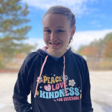 Jordyn, modeling a small, in our new Peace Love Kindness® Hoodie.