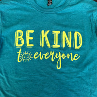 Close up image of the Smiling Sun Be Kind to Everyone® tee in our Long Sleeve Surprise Packs.