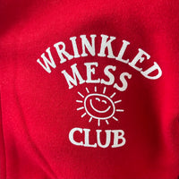 Zoomed in image of the front of our Wrinkled Mess Club Hoodie (design is on the left side).