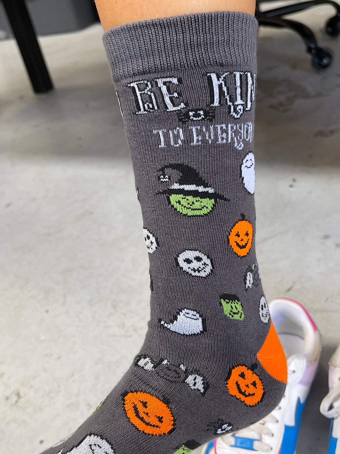 Our Halloween Be Kind to Everyone® socks feature an orange toe and heal.