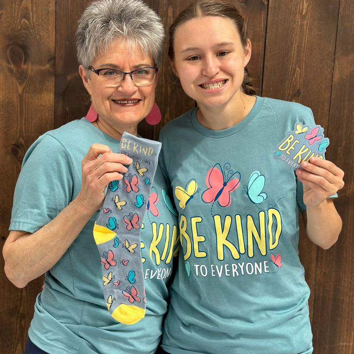 Grandma and Jordyn showcasing the items in our NEW Butterfly Be Kind to Everyone® Tee and Sock Pack.  Grandma is wearing a medium and Jordyn is wearing a small in this photo.