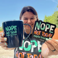 Jackie, holding our Nope Not Today Maybe Tomorrow Coffee Mug and Magnet, while outside.