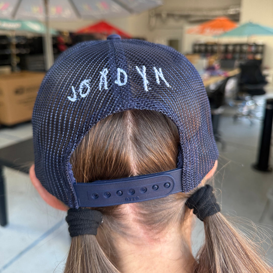 Jordyn, displaying her signature that is embroidered on the back of our Nope Not Today Maybe Tomorrow Trucker Hat.