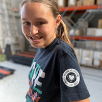 Jordyn, displaying the Be Kind to Everyone® logo on the sleeve of our short-sleeved Nope Not Today t-shirt.