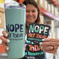 Jackie, displaying our Nope Not Today tumbler and coordinating magnet, with the Shirt Shop in the background.