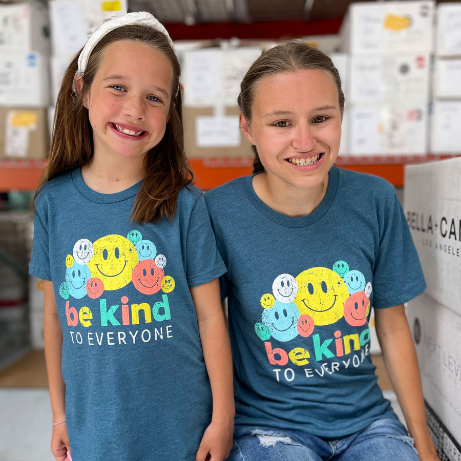 Jordyn and Katie modeling our Smiley Be Kind to Everyone® short-sleeved t-shirt. Katie is wearing a youth medium and Jordyn is wearing an adult small.