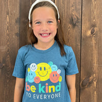 Katie, modeling a youth medium in our Smiley Be Kind to Everyone® short-sleeved t-shirt.
