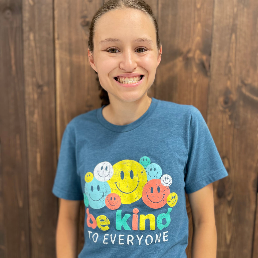 Jordyn, modeling a small in our Smiley Be Kind to Everyone® short-sleeved t-shirt.