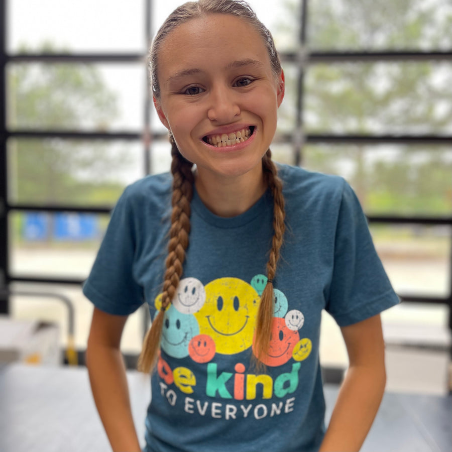 Jordyn, modeling a small in our Smiley Be Kind to Everyone® short-sleeved t-shirt.