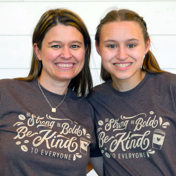Jackie (left) and Jordyn (right) wearing our short-sleeve "Coffee" Be Kind to Everyone® shirt.  They are both wearing smalls in this photo.