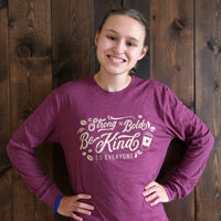 Jordyn modeling a small in our Coffee Be Kind to Everyone® long-sleeved t-shirt.