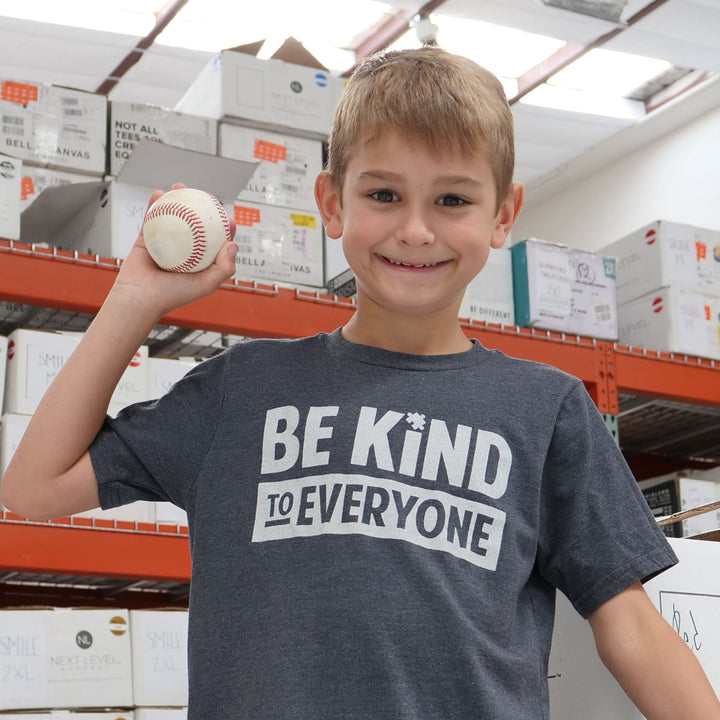 Hudson modeling our gray Hudson Be Kind to Everyone® short-sleeved t-shirt.