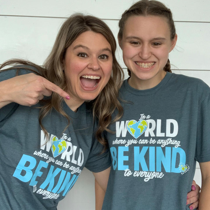 Jackie (left) and Jordyn (right), wearing our In a World Where You Can Be Anything, Be Kind to Everyone® short-sleeve tees.  Jackie is wearing a medium; Jordyn is wearing a small.