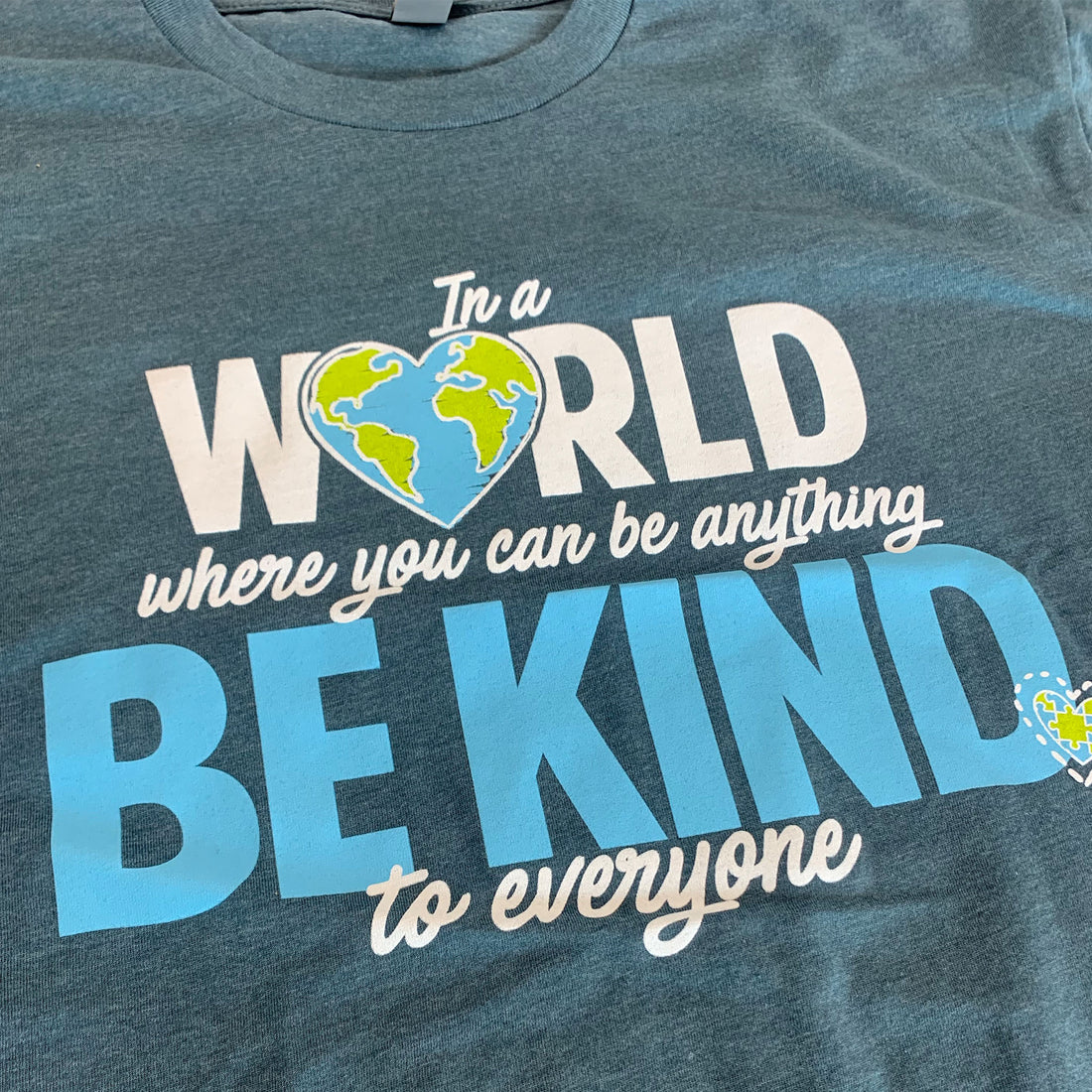 Close up of our In a World Where You Can Be Anything, Be Kind to Everyone®, short-sleeve tee.
