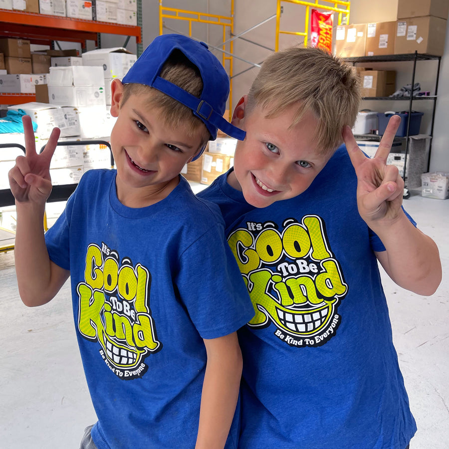 Hudson and friend sporting our It's Cool to Be Kind to Everyone® youth shirts that feature two-tone lettering.
