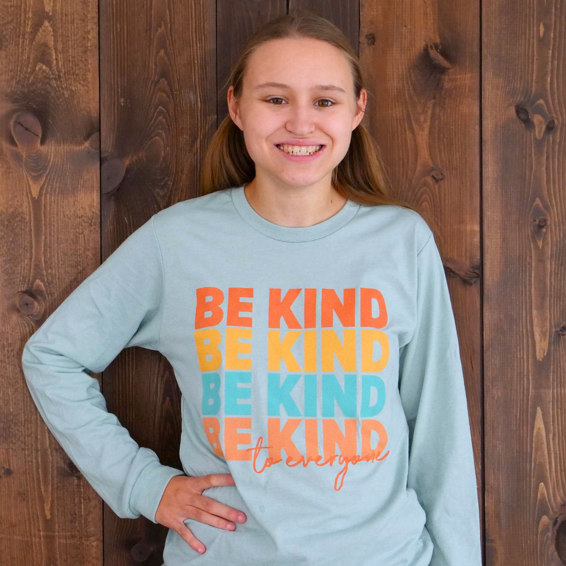 Jordyn wearing a small in our Repeating Kindness Be Kind to Everyone® long-sleeved t-shirt.