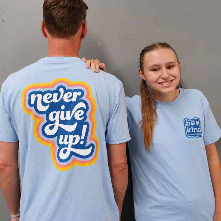 Front and back of our "Never Give Up" Be Kind to Everyone® short-sleeve tee.