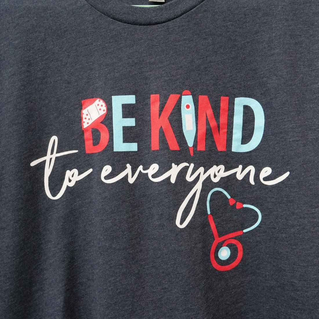 Close up of our new "Nurse" Be Kind to Everyone® shirt.