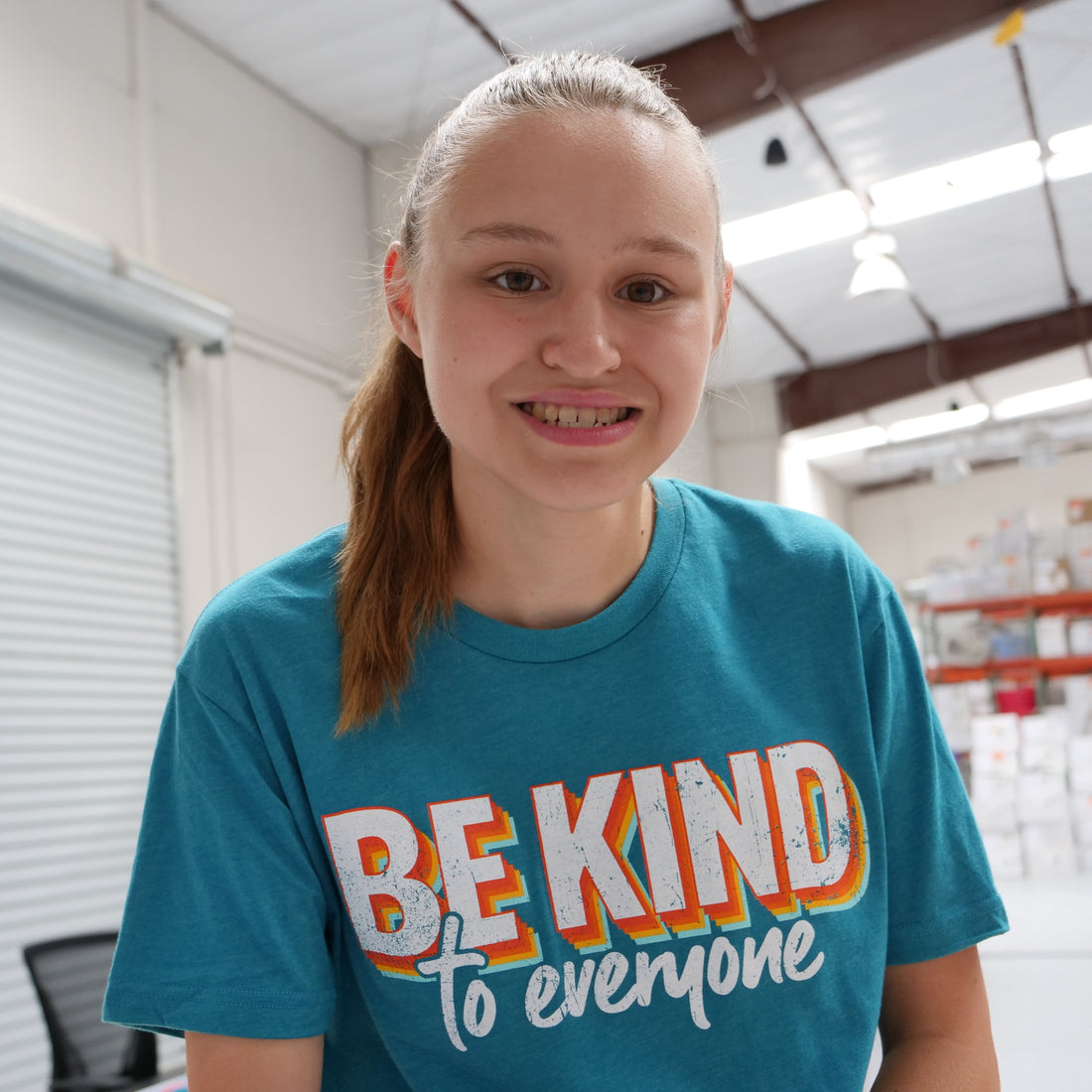 Jordyn, at the shirt shop, wearing our 3D Be Kind to Everyone® short-sleeve shirt.