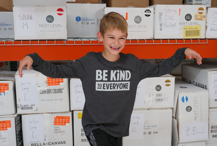 Hudson, having fun at the shirt shop while wearing a youth long-sleeved Hudson Be Kind to Everyone® t-shirt (that's named after him).