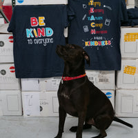 Our dog Max, proudly posing in front of our "T.E.A.C.H. Kindness" Be Kind to Everyone® short-sleeve tee.