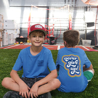 Hudson and friend modeling the front and back of our Never Give Up Be Kind to Everyone® short-sleeved youth t-shirt.