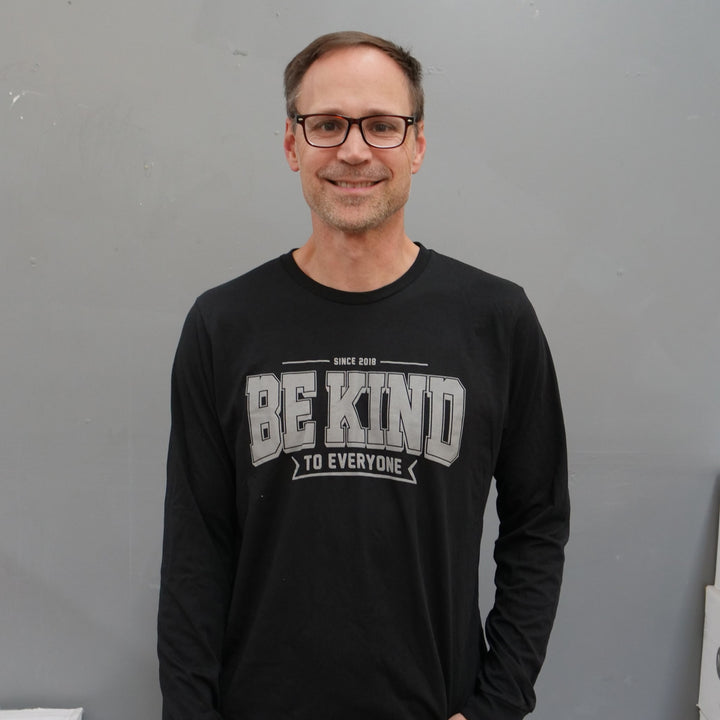Ben, modeling a large in our Ben Be Kind to Everyone® long-sleeved t-shirt.