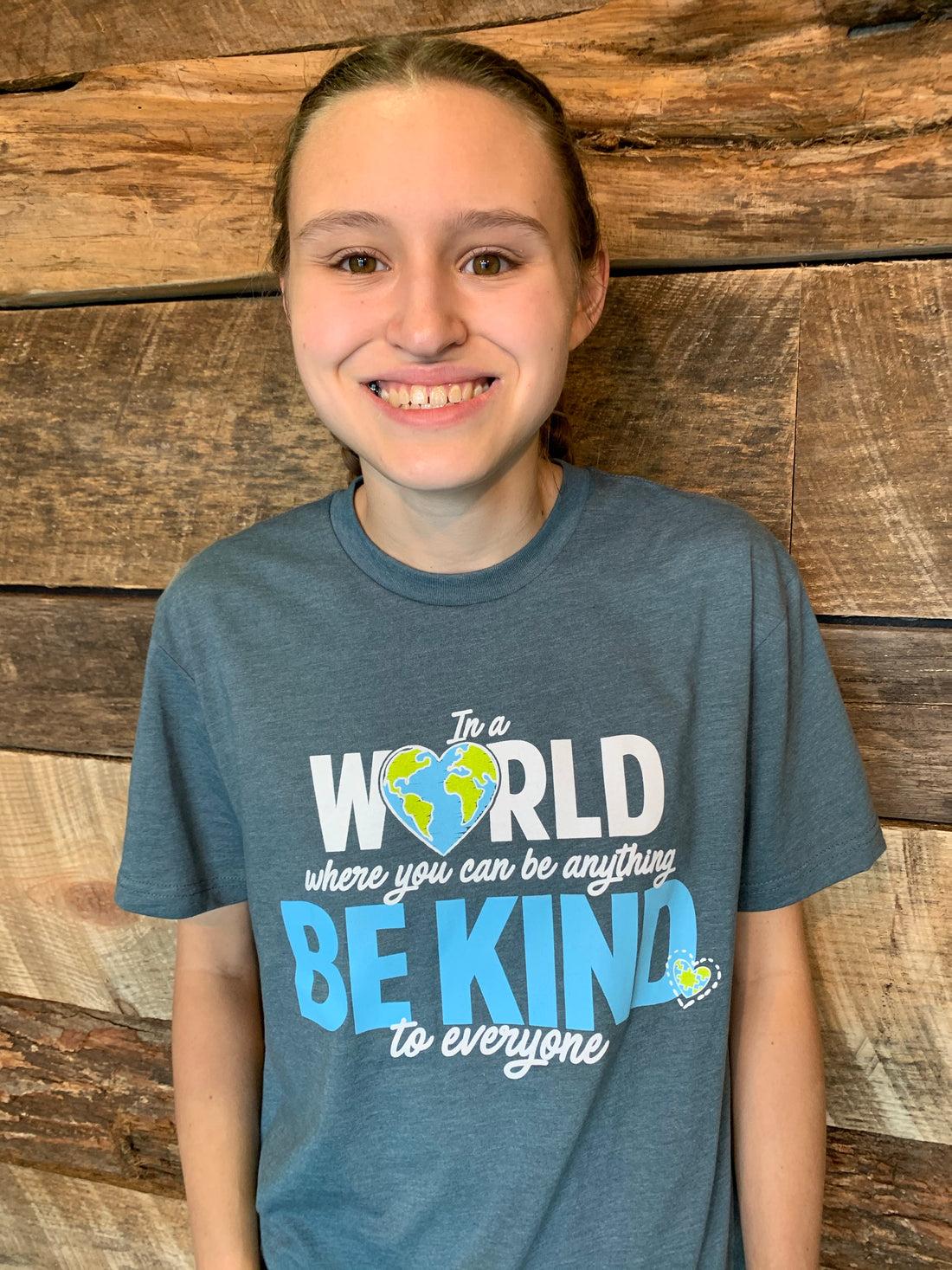 Jordyn wearing our In a World Where You Can Be Anything, Be Kind to Everyone®, short-sleeve tee in a small.