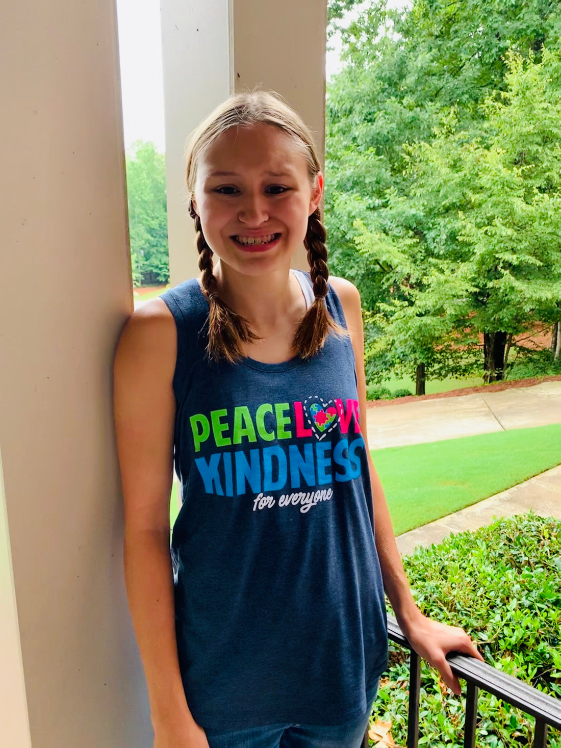 Jordyn, modeling a small in our Peace, Love, and Kindness for Everyone® adult racerback tank top.